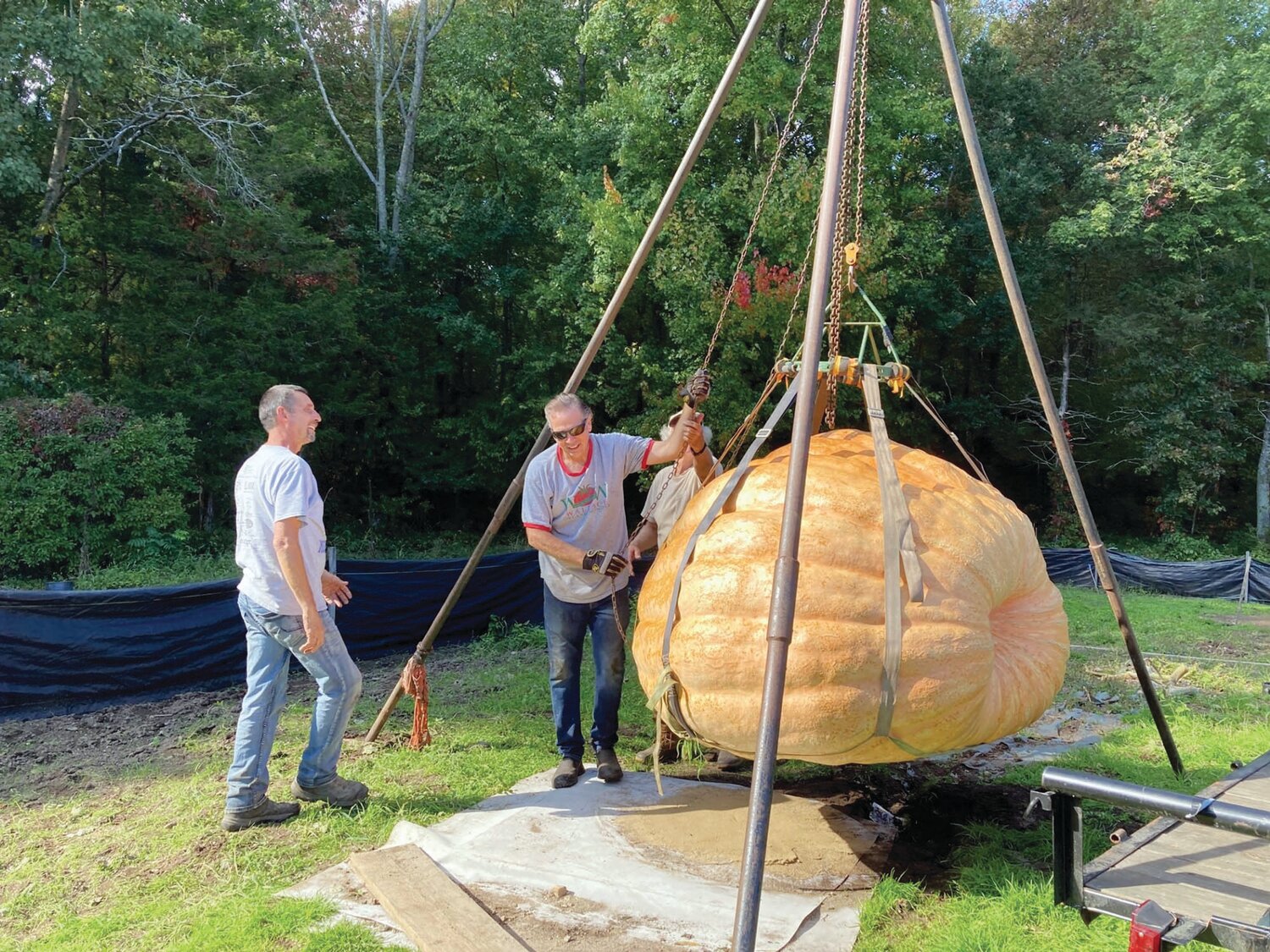 MONSTER MELON: Most of Steve Sperry’s pumpkins weigh a ton, literally. Here he hoists one of his monsters from his backyard garden. The pumpkin went on to win first place at the Topsfield Fair in Massachusetts.
